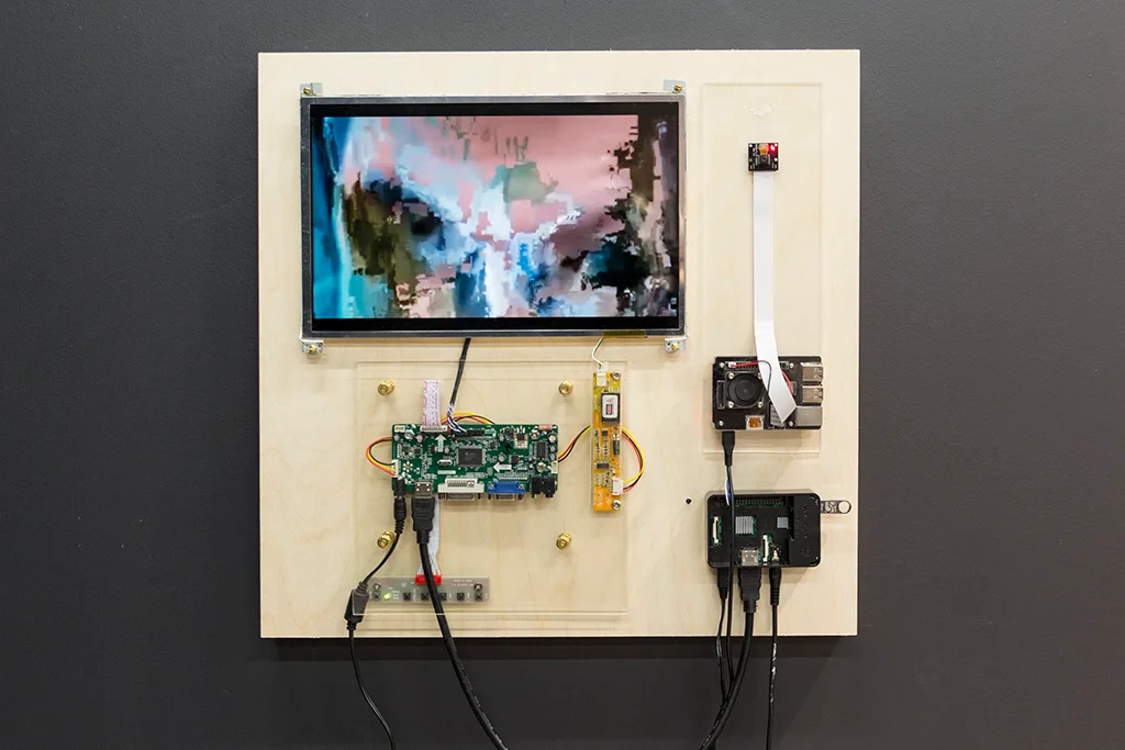 Transceiver panel with screen, camera, and exposed electronics