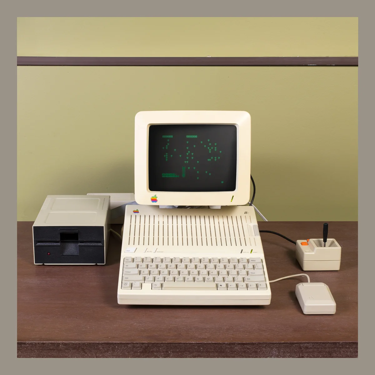 Apple IIc computer with monitor, disk drive, joystick, and mouse