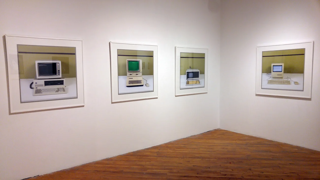 Four framed photographs of early personal computers
