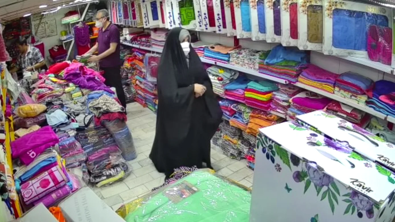 Masked shoppers inside a textile shop