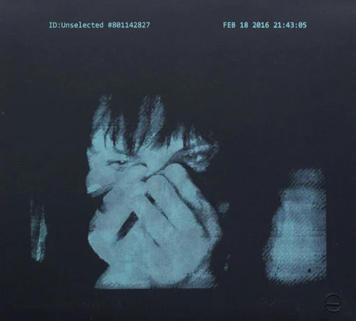 Blue monochrome portrait of a person covering their face