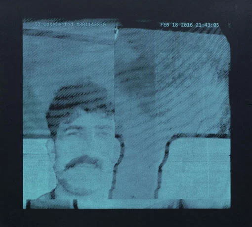 Blue monochrome video-chat portrait of a man