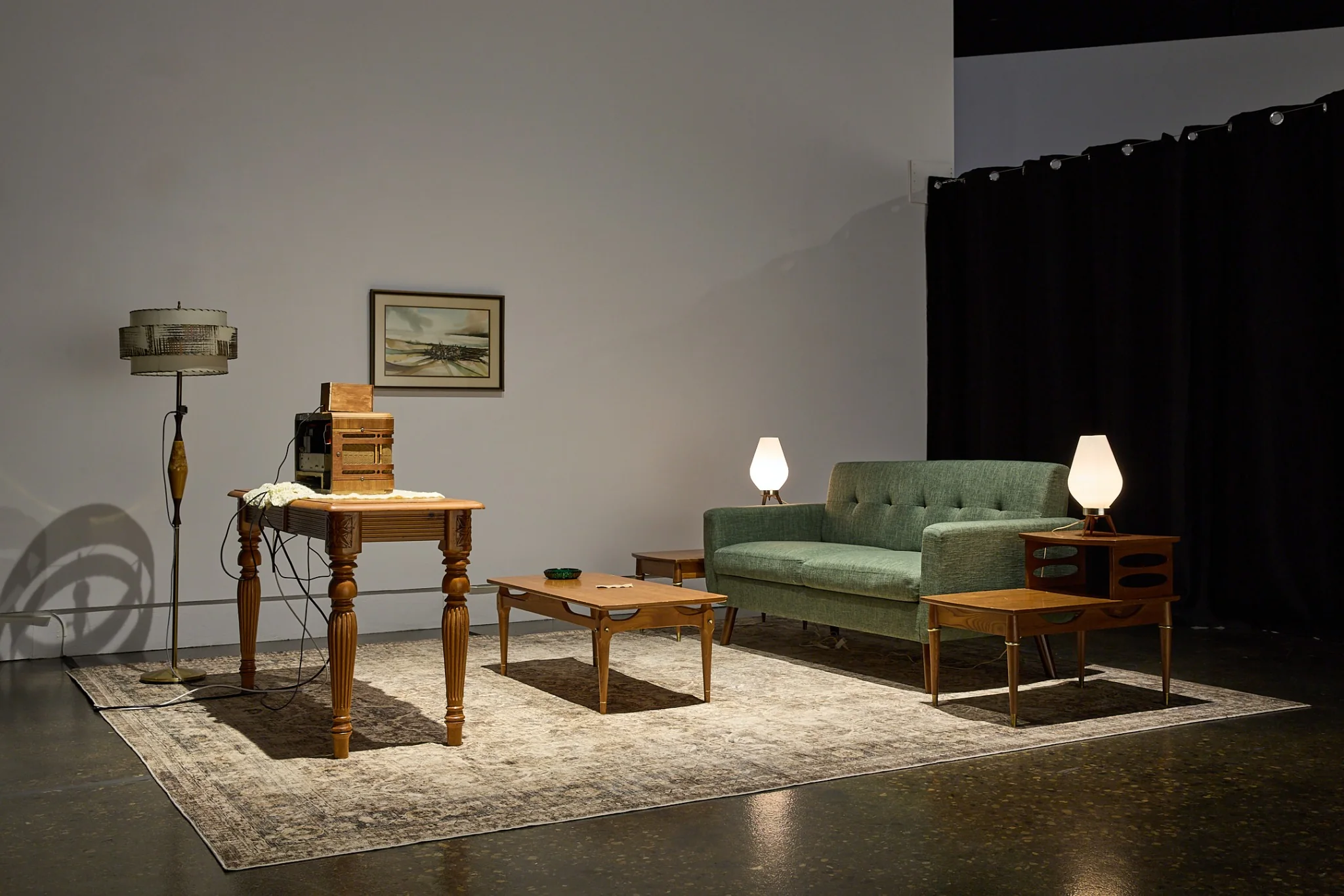 Completed installation of a furnished mid-century living room containing the Victory Box